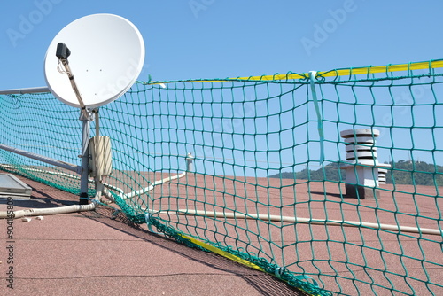 Safety net. Roof safety net.Satellite dish on a roof with a fall protection net for construction work. 