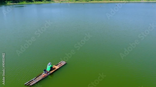 Drone flying through a fisherman on the Gunungrowo reservoir, Pati Indonesia photo