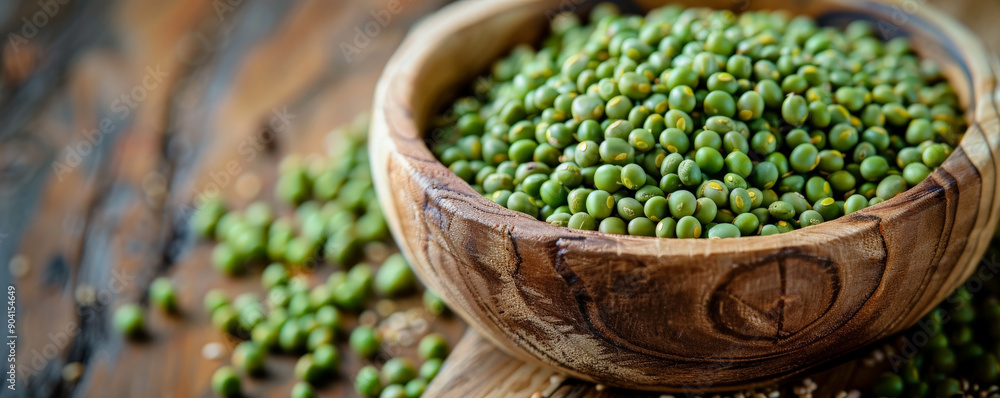 Close-up of a rustic wooden bowl filled with pea groats, showcasing their texture and natural color on a wooden table. Close-up of a rustic wooden bowl filled with pea groats, showcasing their texture and natural color on a wooden table.