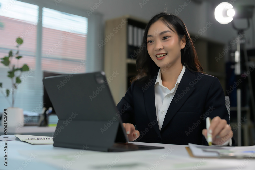 Professional Businesswoman Working on Tablet in Modern Office Setting Professional Businesswoman Working on Tablet in Modern Office Setting