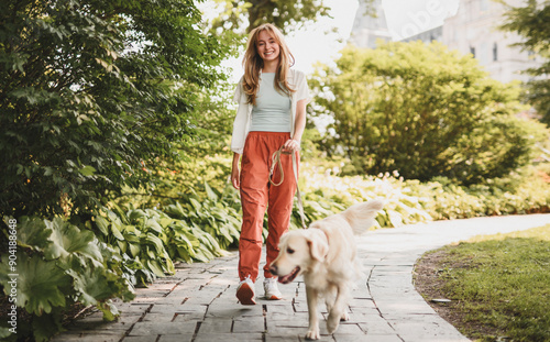 Photography Portrait of teenage girl having fun outside with golden retriever