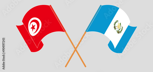 Crossed and waving flags of Tunisia and Republic of Guatemala
