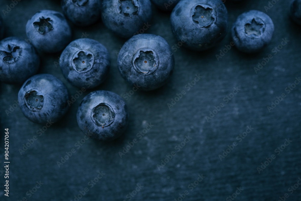 Blueberries background. Blueberry border design. Ripe and juicy fresh picked bilberries close up. Copyspace for your text Blueberries background. Blueberry border design. Ripe and juicy fresh picked bilberries close up. Copyspace for your text