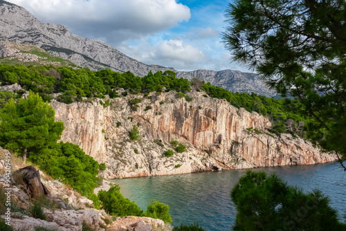 Fototapeta Naklejka Na Ścianę i Meble -  Scenic view of idyllic pebble beach Nugal along Makarska Riviera, Split-Dalmatia, Croatia, Europe. Picturesque coastal scene nestles between towering majestic cliffs at Adriatic Mediterranean sea