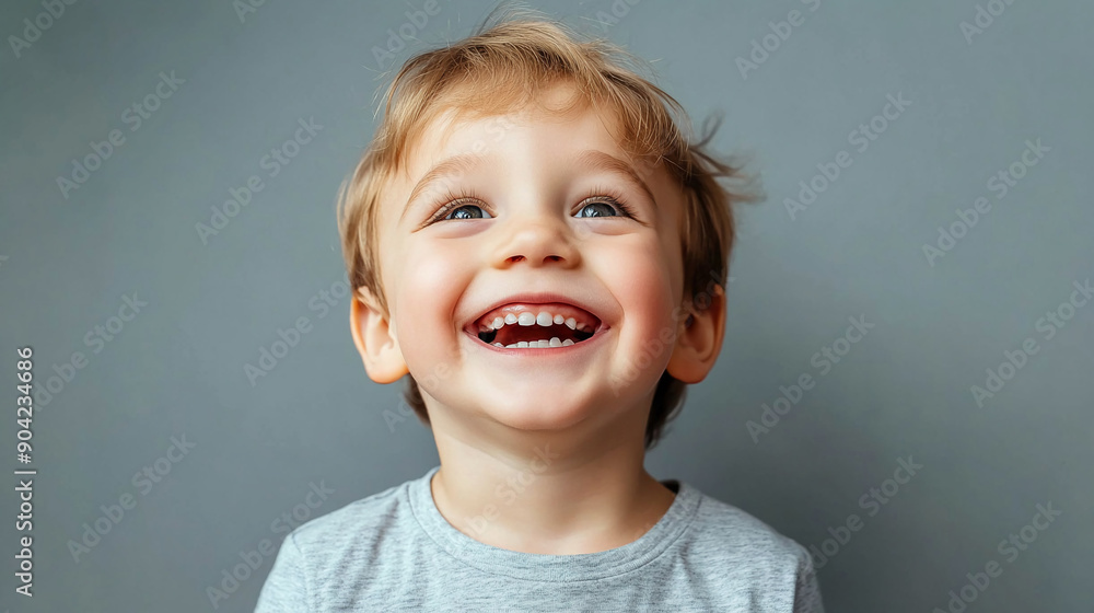 Happy boy against a pastel teal background Happy boy against a pastel teal background