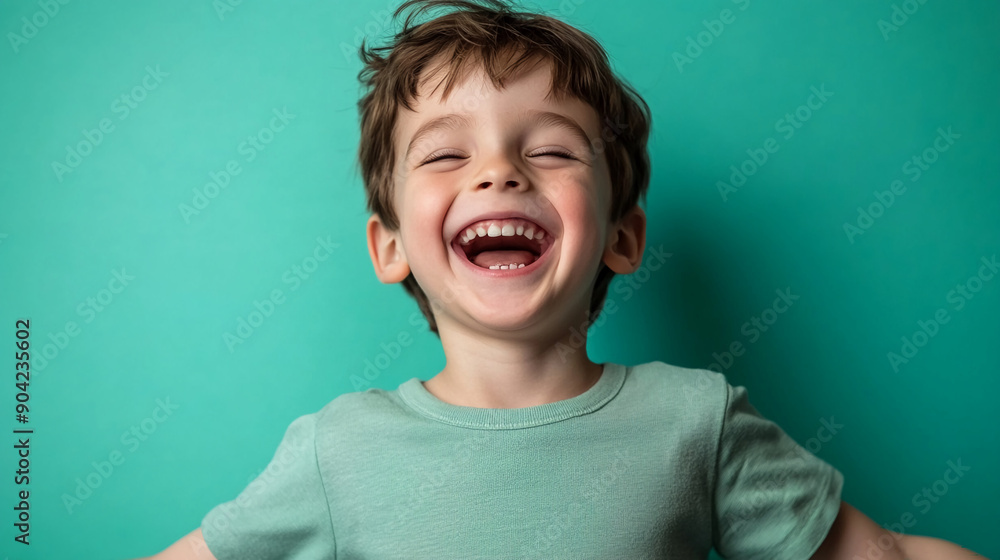 Joyful boy with a pastel green backdrop Joyful boy with a pastel green backdrop