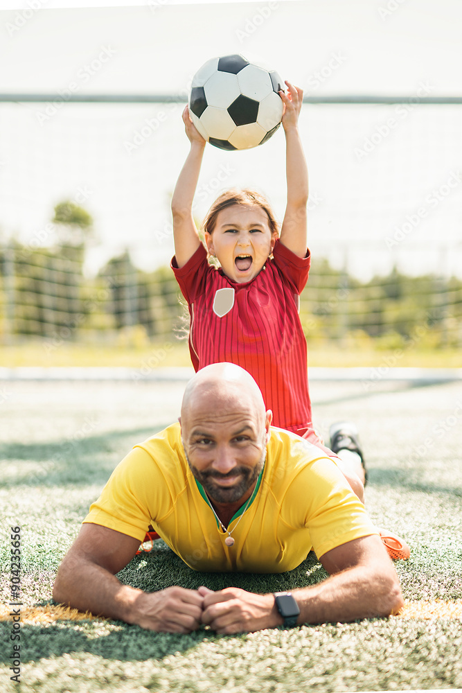 Fototapeta premium soccer, sport with a dad and daughter training on a court outside for leisure fitness and fun