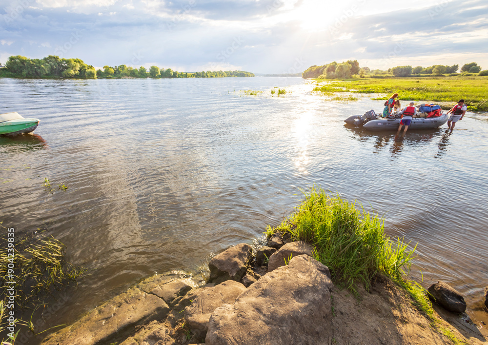 Fototapeta premium A group of people are in a raft on a river