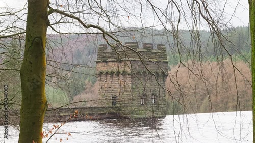 Views of the famous Howden and Derwent stone build Dams, used in the filming of the movie Dam Busters. Showing water overflowing over the dam walls with victorian towers on each side of the structure photo