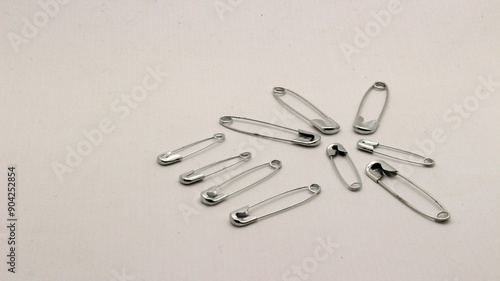 The safety pin is made of metal and silver in color.