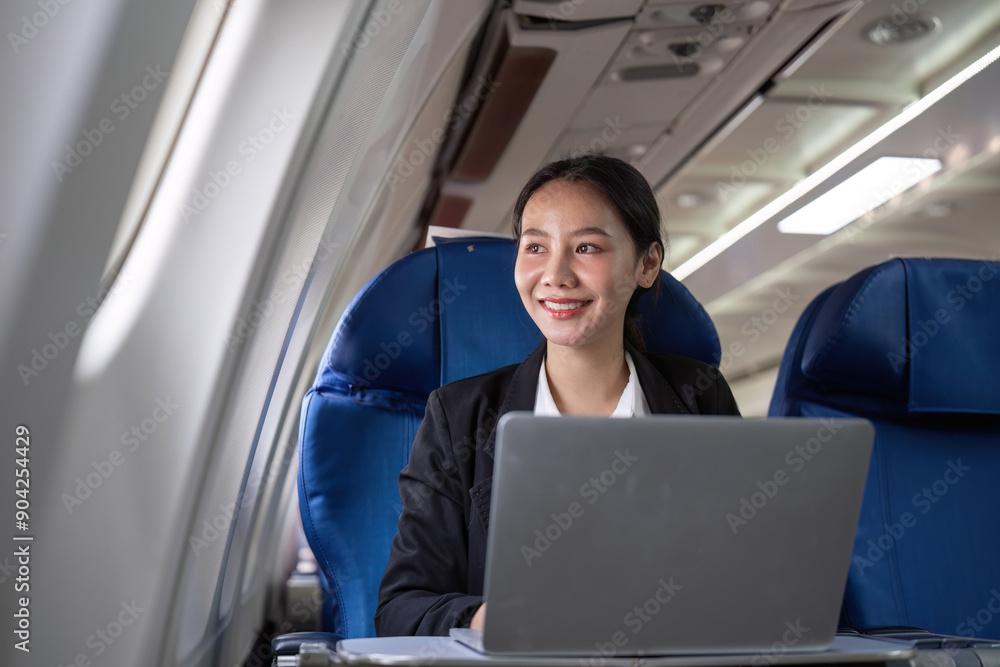 Young Accountant Working Online on Airplane with Laptop, Businesswoman Traveling and Working Remotely in Modern Aircraft Cabin Young Accountant Working Online on Airplane with Laptop, Businesswoman Traveling and Working Remotely in Modern Aircraft Cabin