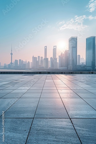 A city skyline with a beautiful sunset in the background. The sky is filled with clouds, and the sun is setting, casting a warm glow over the city