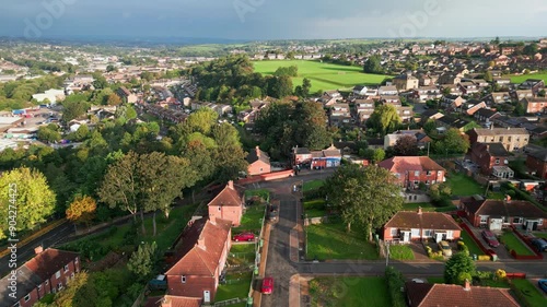 Charming urban living: Red brick council housing in Yorkshire, aerial view, sunny morning, bustling streets.