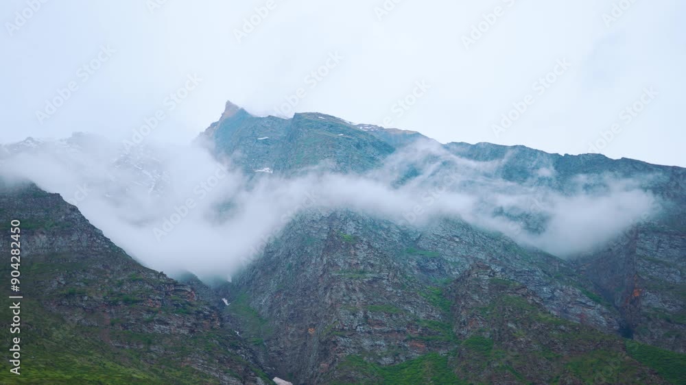 4K Landscape shot of clouds under the Himalayan mountain peaks during the monsoon season as seen from Manali in Himachal Pradesh, India. Clouds under the mountain peaks during the storm. 4K Landscape shot of clouds under the Himalayan mountain peaks during the monsoon season as seen from Manali in Himachal Pradesh, India. Clouds under the mountain peaks during the storm.