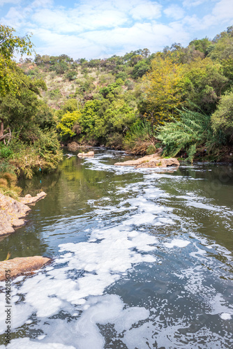 View of a Hennops Hiking Trail, with river running through, small bridge and cableway over the river, Hartbeespoort, Johannesburg, South Africa photo