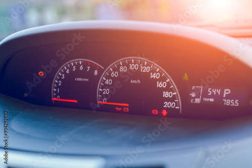 Close-up of a speedometer on a car dashboard showing speed with black and red details