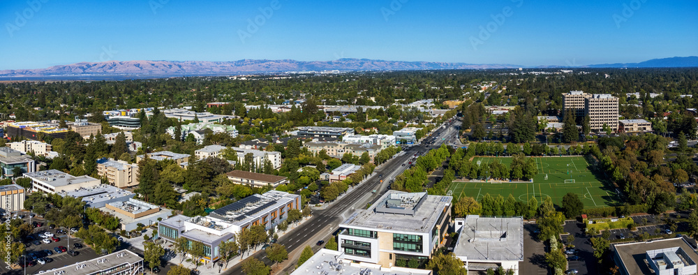 Fototapeta premium Aerial view of commercial and residential areas of Palo Alto, California toward Mountain View along El Camino Real near Page Mill Road