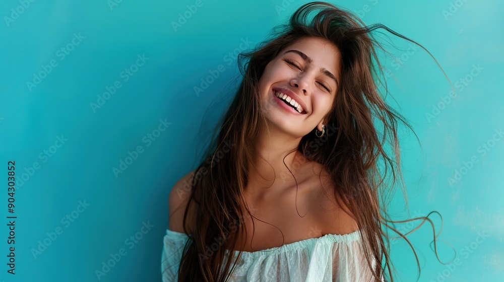 Picture a vibrant woman with long hair, posed against a teal backdrop, smiling with energy and positivity Picture a vibrant woman with long hair, posed against a teal backdrop, smiling with energy and positivity