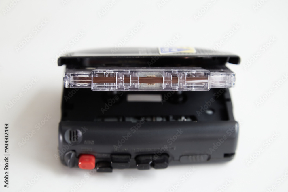 Old tape recorder with open deck and cassette inside on white background, old archival recordings Old tape recorder with open deck and cassette inside on white background, old archival recordings