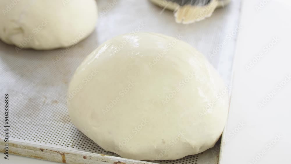 baker working with dough to prepare buns and bread baker working with dough to prepare buns and bread