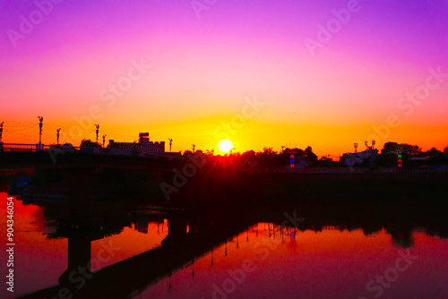 The evening sunset, golden light shines through the Ekatotsarot Bridge across the Nan River, in the heart of Phitsanulok Province, Thailand, Southeast Asia.