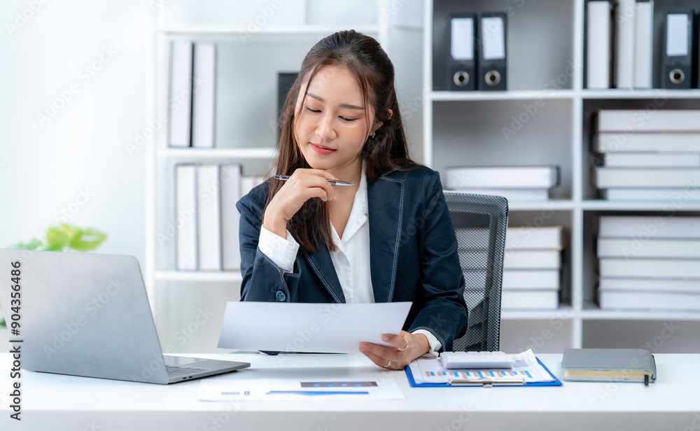 Fototapeta premium Business woman working at desk using laptop Smile and be happy and stay focused.