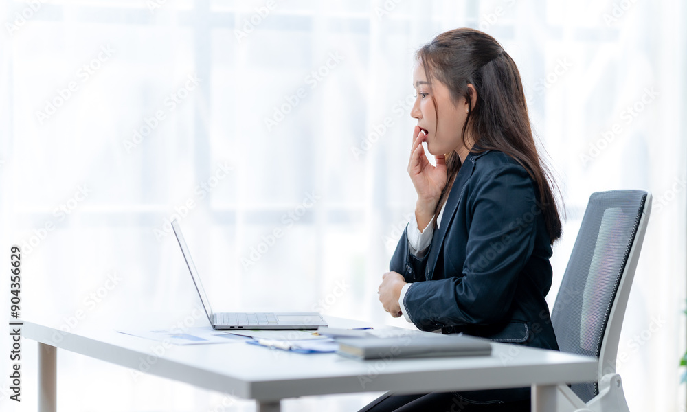 Businesswoman working using laptop at table and talking on phone Businesswoman working using laptop at table and talking on phone