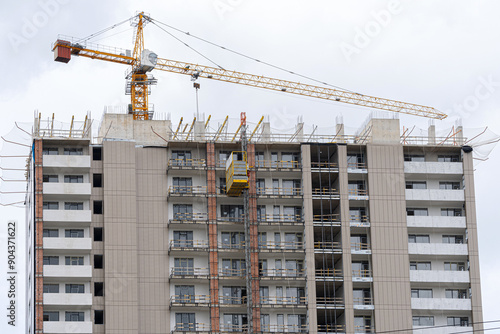 Construction crane at the construction of a new house.