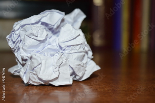 white crumpled paper ball with specular photo