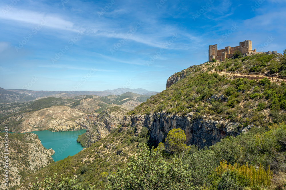 Spectacular view of the Chirel castle in the town of Cortes de Pallas, Valencia, Spain, on a hill and with the Cortes II reservoir between the mountains Spectacular view of the Chirel castle in the town of Cortes de Pallas, Valencia, Spain, on a hill and with the Cortes II reservoir between the mountains