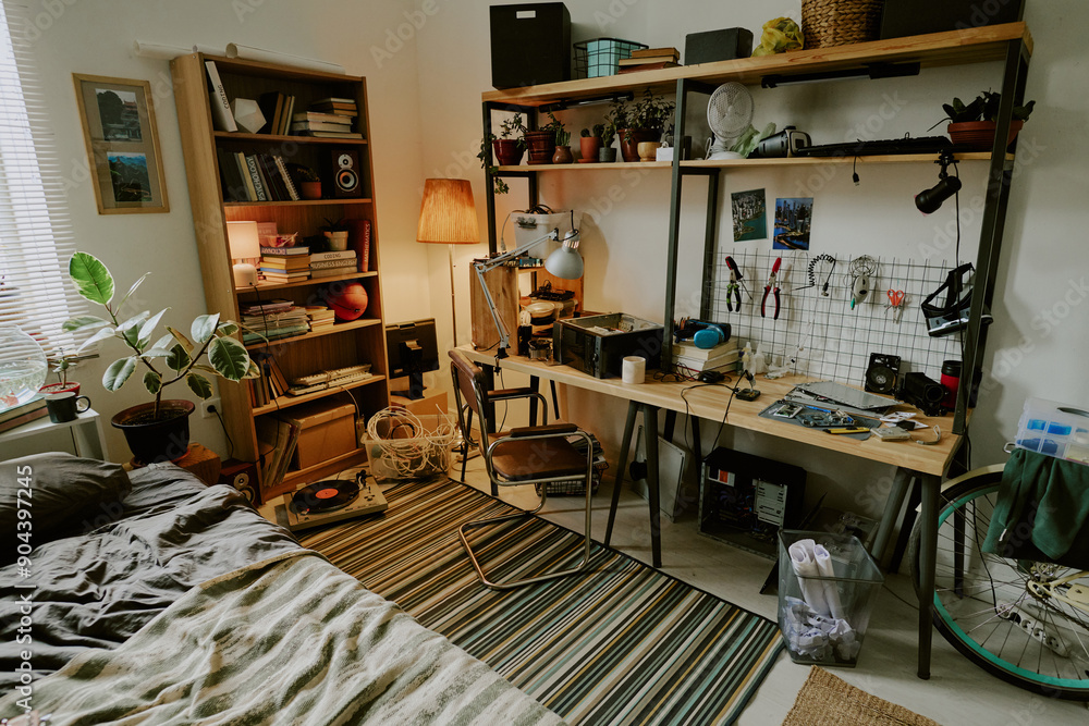 High angle shot of technician workspace with tools in messy dorm bedroom High angle shot of technician workspace with tools in messy dorm bedroom