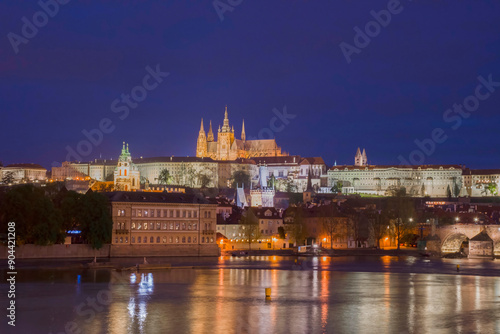 Vltava river with famous Hradcany castle and St. Vitus Cathedral in Prague, Czech Republic, by night