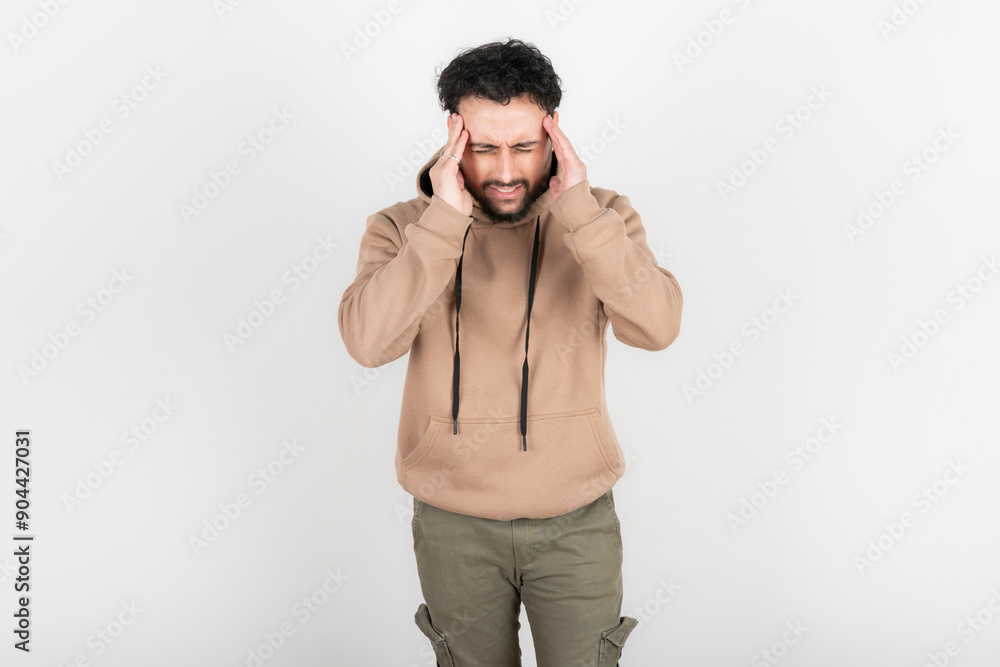 Stressed and tired man touches his head because of a headache Stressed and tired man touches his head because of a headache