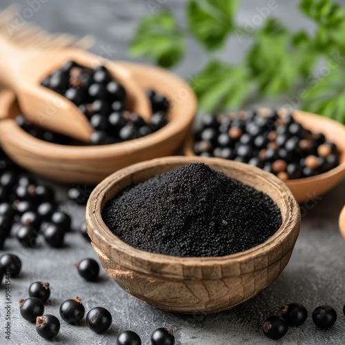 Black Currants and Powder Displayed in Rustic Bowls on Grey Countertop