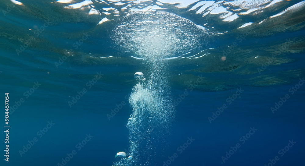 Fototapeta premium Underwater view with bubbles rising to the surface in a deep blue ocean. the serenity and mystery of the underwater world created with generative ai.