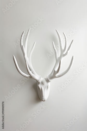 White antlers mounted as a minimalist wall decoration, emphasizing modern and elegant interior design with a touch of rustic charm photo