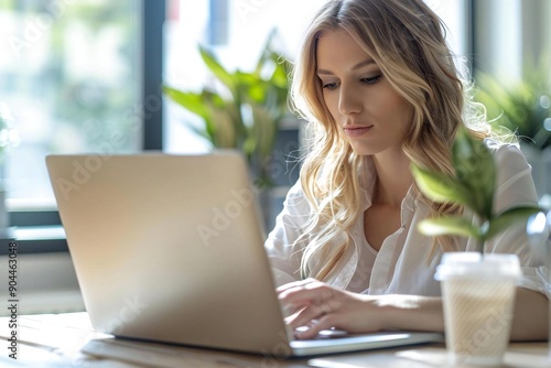 Close-up of a Businesswoman Working on a Laptop with a Disposable Cup Free Download Close-up of a Businesswoman Working on a Laptop with a Disposable Cup - GFXLoad