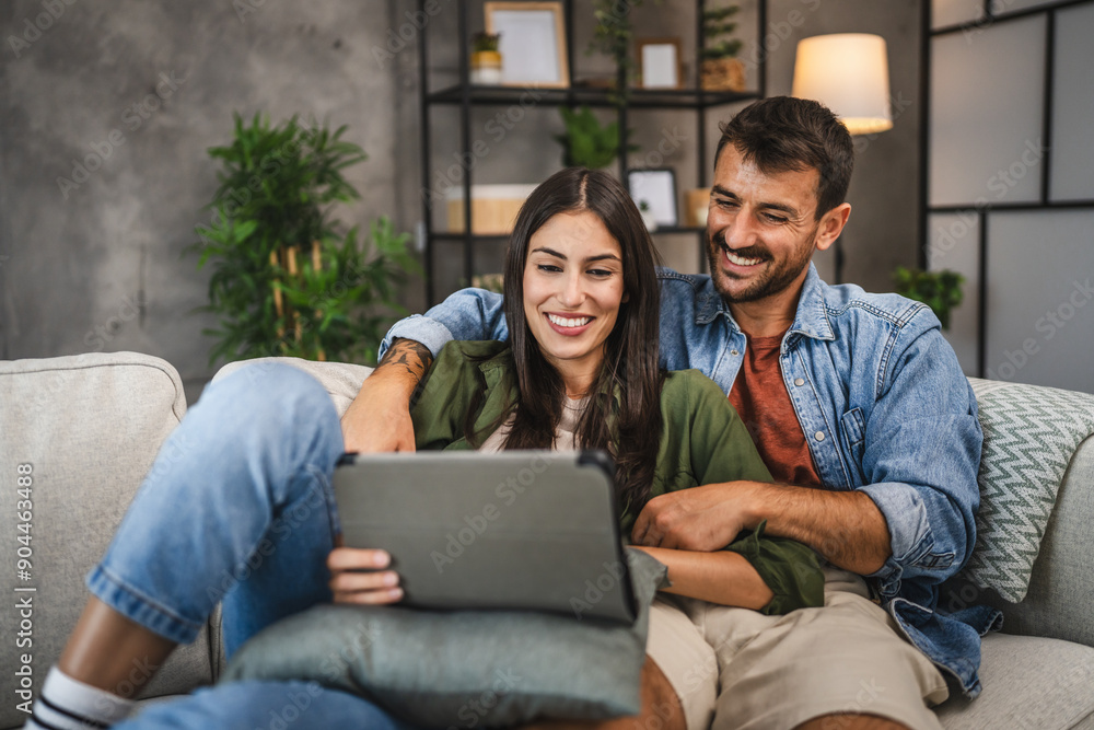adult couple watch movie, a series on digital tablet at home adult couple watch movie, a series on digital tablet at home