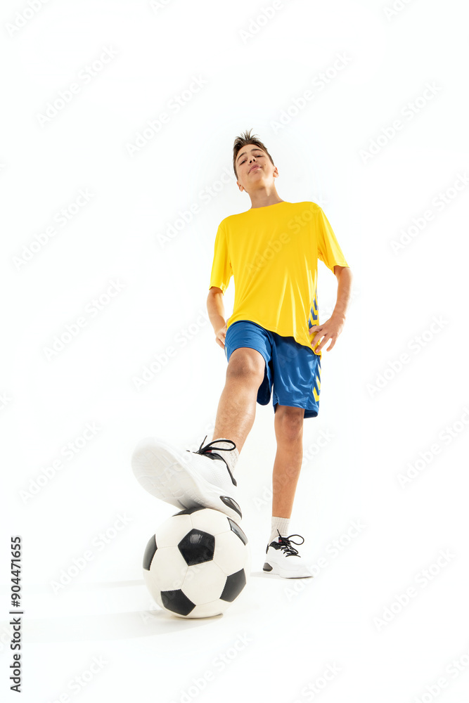 Photo of smiling teen boy in sportswear and soccer ball posing on white studio background. Photo of smiling teen boy in sportswear and soccer ball posing on white studio background.