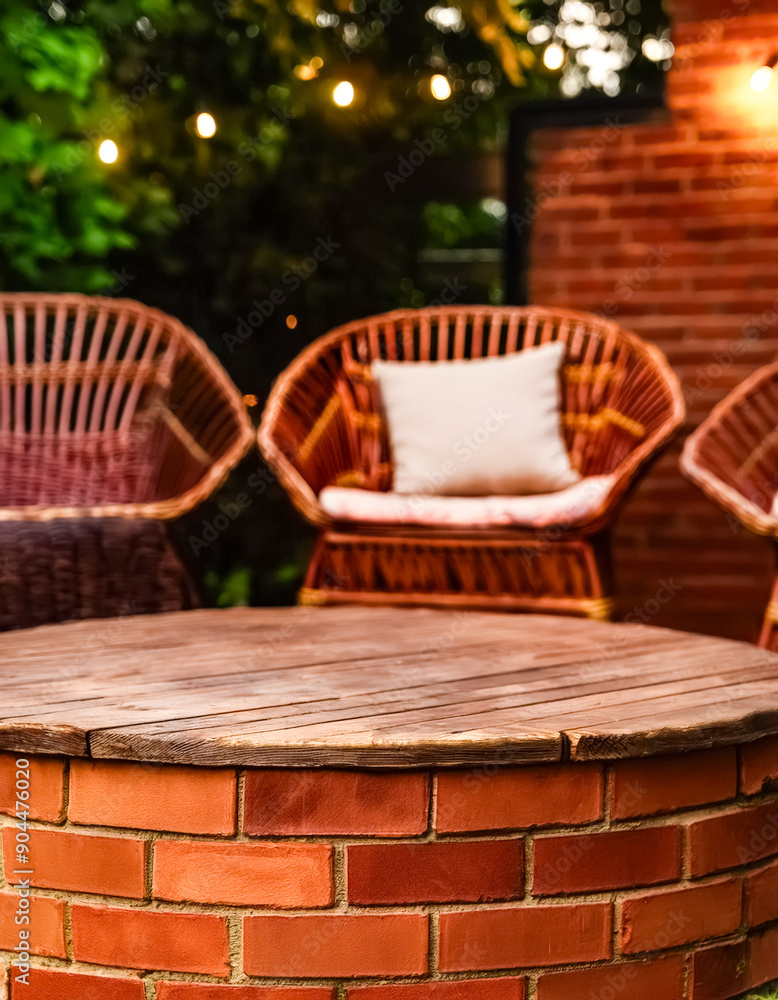 Fototapeta premium Rustic Wooden Table Top With Brick Base In A Cozy Outdoor Setting