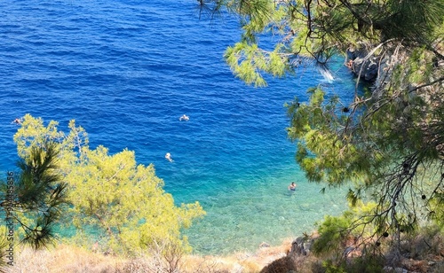 Fototapeta Naklejka Na Ścianę i Meble -  Top view of the idyllic Avlaki beach on Hydra Island, Greece. Located on Hydra Island's eastern side. This charming and serene spot is renowned for its crystal-clear waters and rocky shoreline.