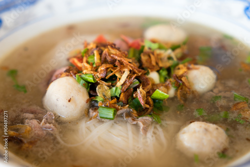 Authentic Lao Noodle Soup with Flavorful Meatballs, Onions and Fresh Herbs - A Taste of Traditional Lao and northern Thai Cuisine (Kuay Tiew, Khao Piak Sen or Kuay Teow) photo