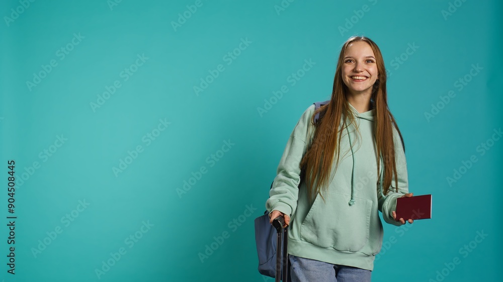 Jolly teenage woman holding passport, going on adventure trip, looking around. Cheerful wanderlust tourist backpacking, sightseeing, visiting attractions, isolated over studio backdrop, camera B Jolly teenage woman holding passport, going on adventure trip, looking around. Cheerful wanderlust tourist backpacking, sightseeing, visiting attractions, isolated over studio backdrop, camera B
