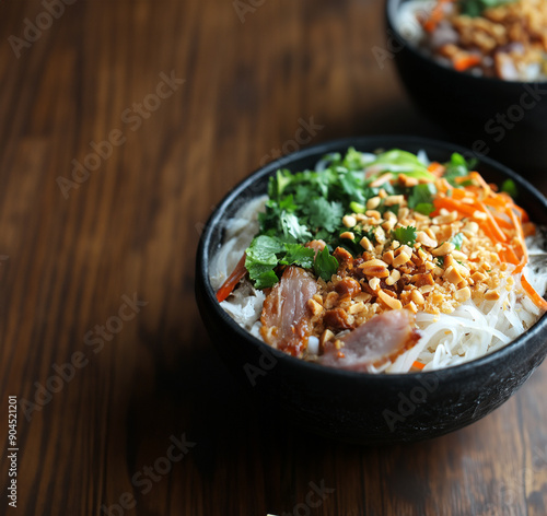 Vietnamese bun, nuoc Cham or rice noodles served with fresh ingredients - bun - bowls of vermicelli noodles on a wooden table photo