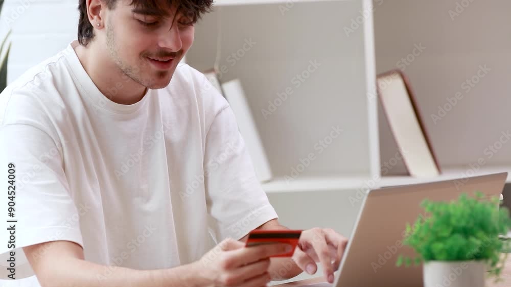 young man or student at home with laptop and credit card shopping or paying online young man or student at home with laptop and credit card shopping or paying online