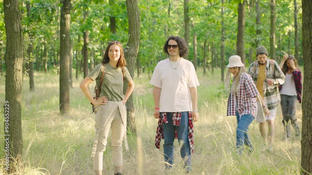 A group of hiking friends get lost on a hiking trail in a lush green forest while looking for a camping spot. A group of hiking friends get lost on a hiking trail in a lush green forest while looking for a camping spot.