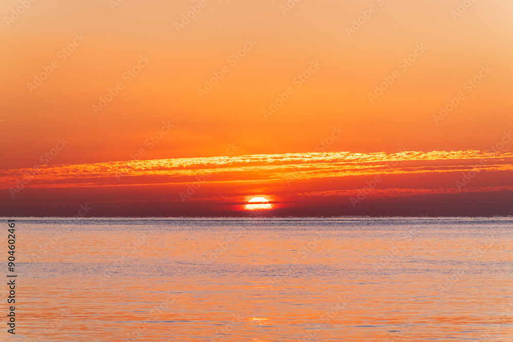Fototapeta premium Beautiful red and orange sunrise over the sea.