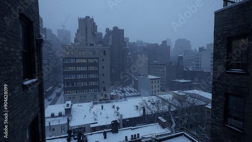 Urban buildings covered in snow under an early evening sky create a winter wonderland in the city photo