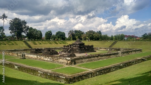 Tableau sur toile Candi Sambisari is situated amidst a beautiful landscape in Kalasan, Sleman, Yogyakarta, surrounded by vast expanses of lush green grass