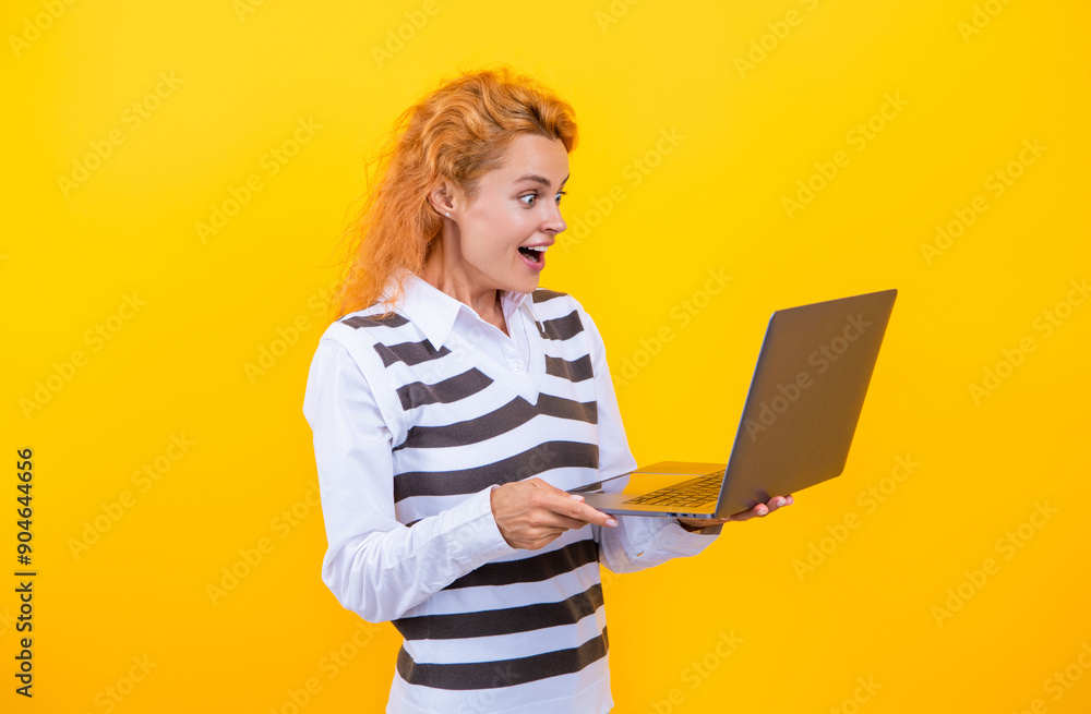 Business success. Businesswoman working on laptop isolated on yellow. Business woman typing on laptop. Business woman working online. Successful businesswoman freelancing online. Freelance gig Business success. Businesswoman working on laptop isolated on yellow. Business woman typing on laptop. Business woman working online. Successful businesswoman freelancing online. Freelance gig